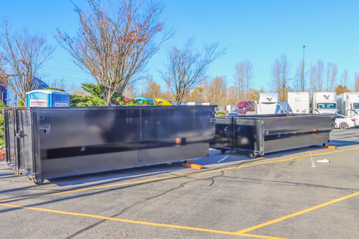 Professional dumpster rental service with roll-off container on residential driveway in Mesquite